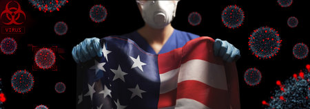 doctor in goggles and mask holding flag of americaの写真素材