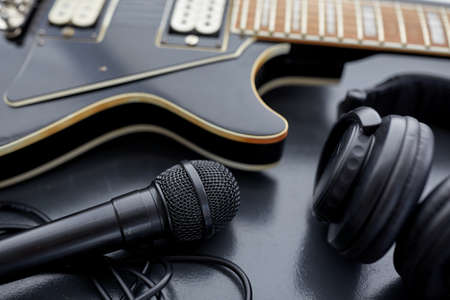 close up of bass guitar, microphone and headphonesの写真素材