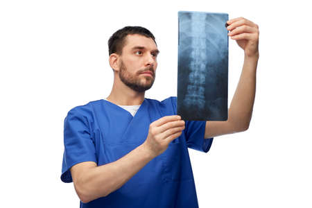 doctor or male nurse looking at x-ray scan