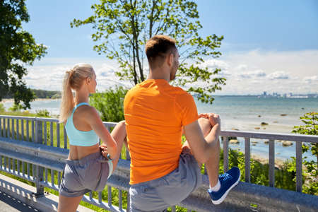 young sporty couple stretching legs