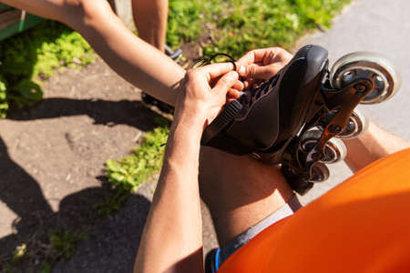 man helping woman to put on shoes
