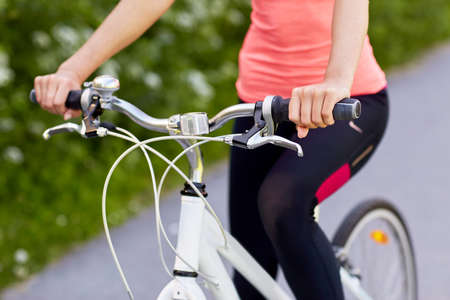 young woman with bicycle outdoors