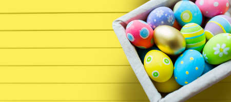 close up of colored easter eggs in basket