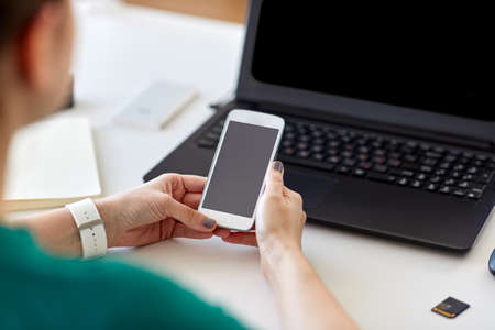 woman smartphone and laptop working at home