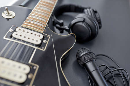 close up of bass guitar, microphone and headphonesの写真素材