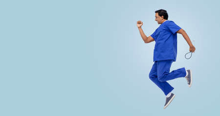 doctor or male nurse with stethoscope jumping