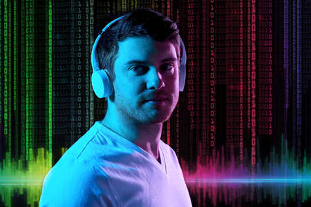 man in headphones over neon lights and binary code