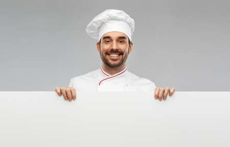 happy smiling male chef with big white boardの写真素材