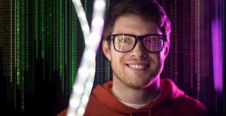 man in glasses over neon lights and binary codeの写真素材