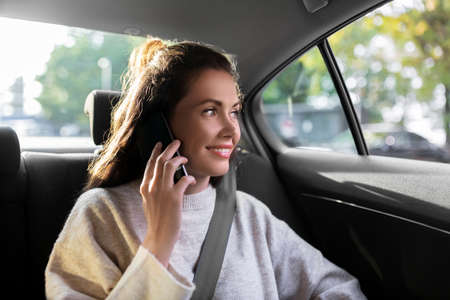 woman in taxi car calling on smartphone