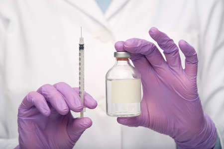 close up of doctor with medicine and syringe
