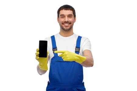 happy male worker or cleaner showing smartphoneの写真素材