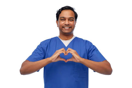 smiling indian male doctor showing hand heartの写真素材