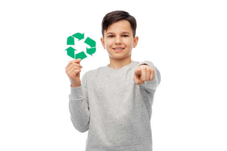 happy boy with recycling sign pointing to youの写真素材