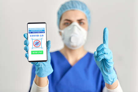 doctor with immunity passport on smartphone screen