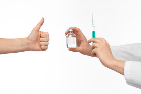hand with medicine and showing thumbs upの写真素材