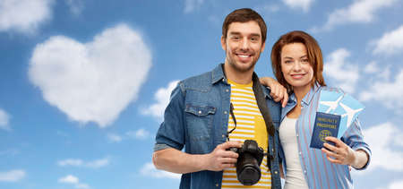 couple with tickets, immunity passport and cameraの写真素材