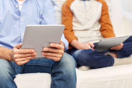father and son with tablet pc at home
