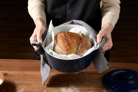 female baker with homemade bread at bakery