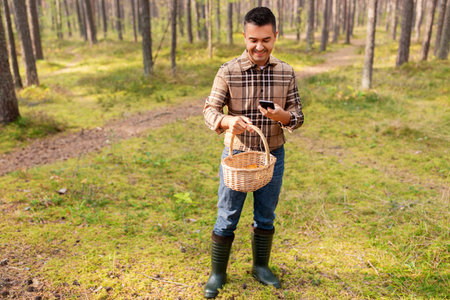 man using smartphone to identify mushroom