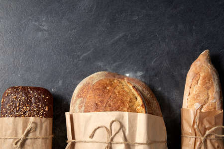 close up of bread in paper bags on table