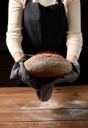 female baker with homemade bread at bakery
