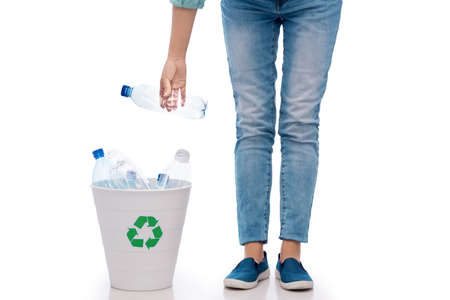 recycling, waste sorting and sustainability concept - close up of young woman holding bucket with plastic bottles over white backgroundの写真素材