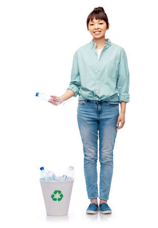 smiling young woman sorting plastic wasteの写真素材