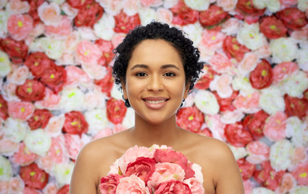 portrait of african american woman with flowersの写真素材