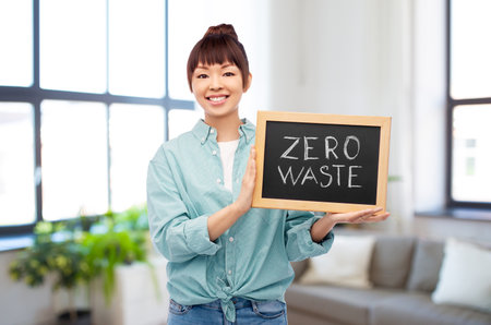 asian woman holds chalkboard with zero waste wordsの写真素材