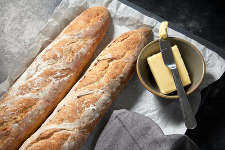 close up of bread, butter and knife on towel