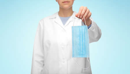female doctor showing medical mask