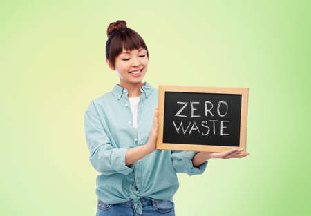 asian woman holds chalkboard with zero waste wordsの写真素材