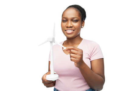 happy african american woman with toy wind turbineの写真素材