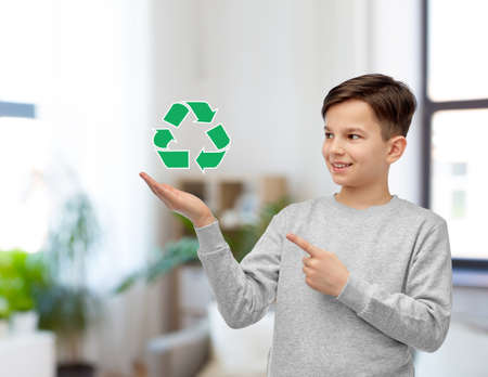smiling boy showing green recycling signの写真素材