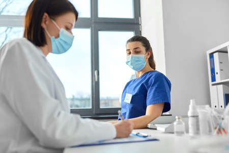 doctor with clipboard and nurse at hospital