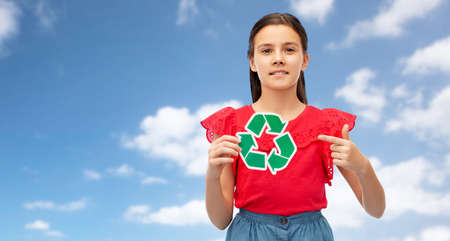 smiling girl holding green recycling signの写真素材
