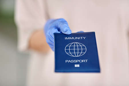 woman in glove holding immunity passport