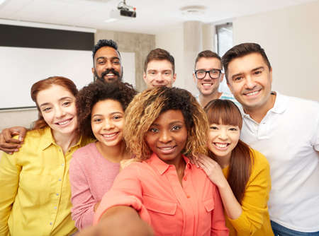 international students and teacher taking selfie