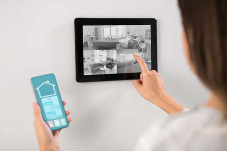 woman having video control from tablet pc at home