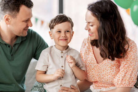 happy family with little son at birthday party