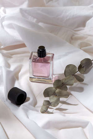 bottle of perfume and on white sheet