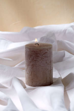 burning aroma candle on white sheetの写真素材