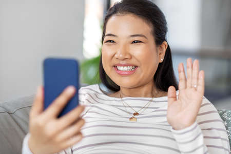 asian woman with smartphone having video callの写真素材