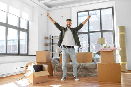 happy man with boxes moving to new home