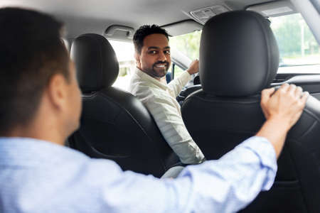 middle aged male passenger talking to car driver
