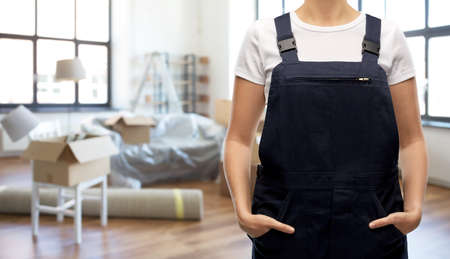 close up of female worker in overall at new homeの写真素材