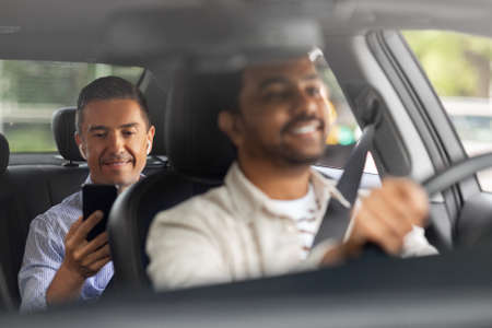 male passenger with smartphone in taxi car