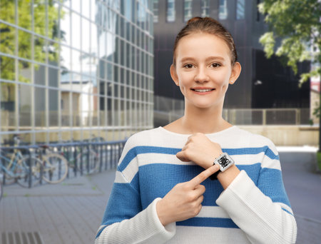 teenage girl showing smart watch with qr codeの写真素材