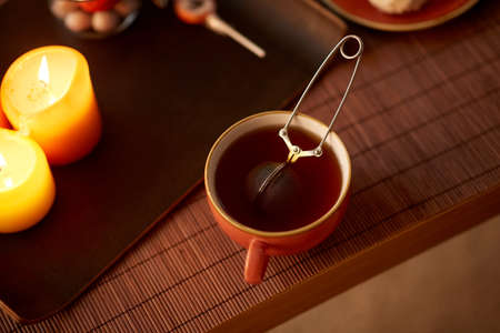 mesh tea infuser ball in ceramic mug on halloweenの写真素材